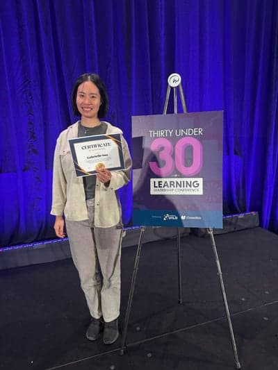 Gabrielle Sun receiving a Learning Guild 30 Under 30 certificate